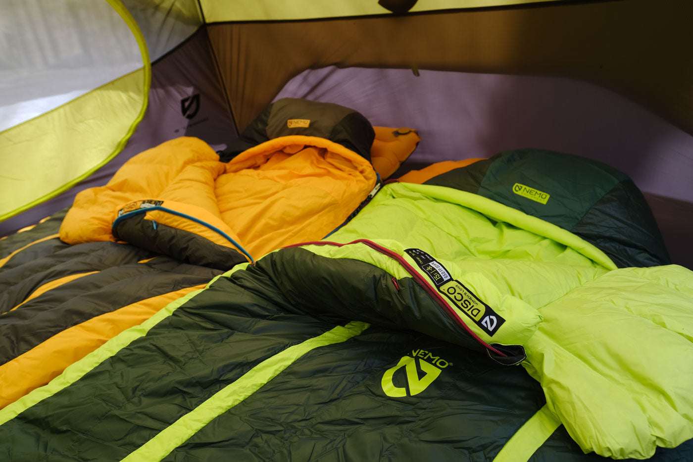 Person sleeping in a Nemo sleeping bag outdoors